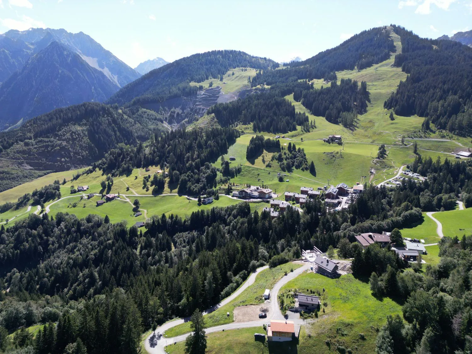 Aerial view of the Tschengla plateau project site showing directions to Arlberg, Montafon and Brandnertal